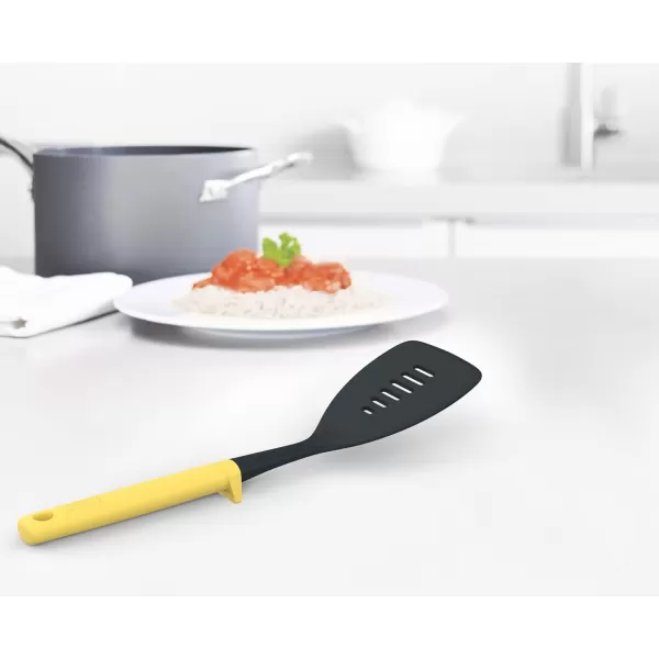 imageJoseph Joseph Duo Slotted Turner with Integrated Tool Rest Hygienic HeatResistant Nylon Head Safe for NonStick Cookware Light Yellow