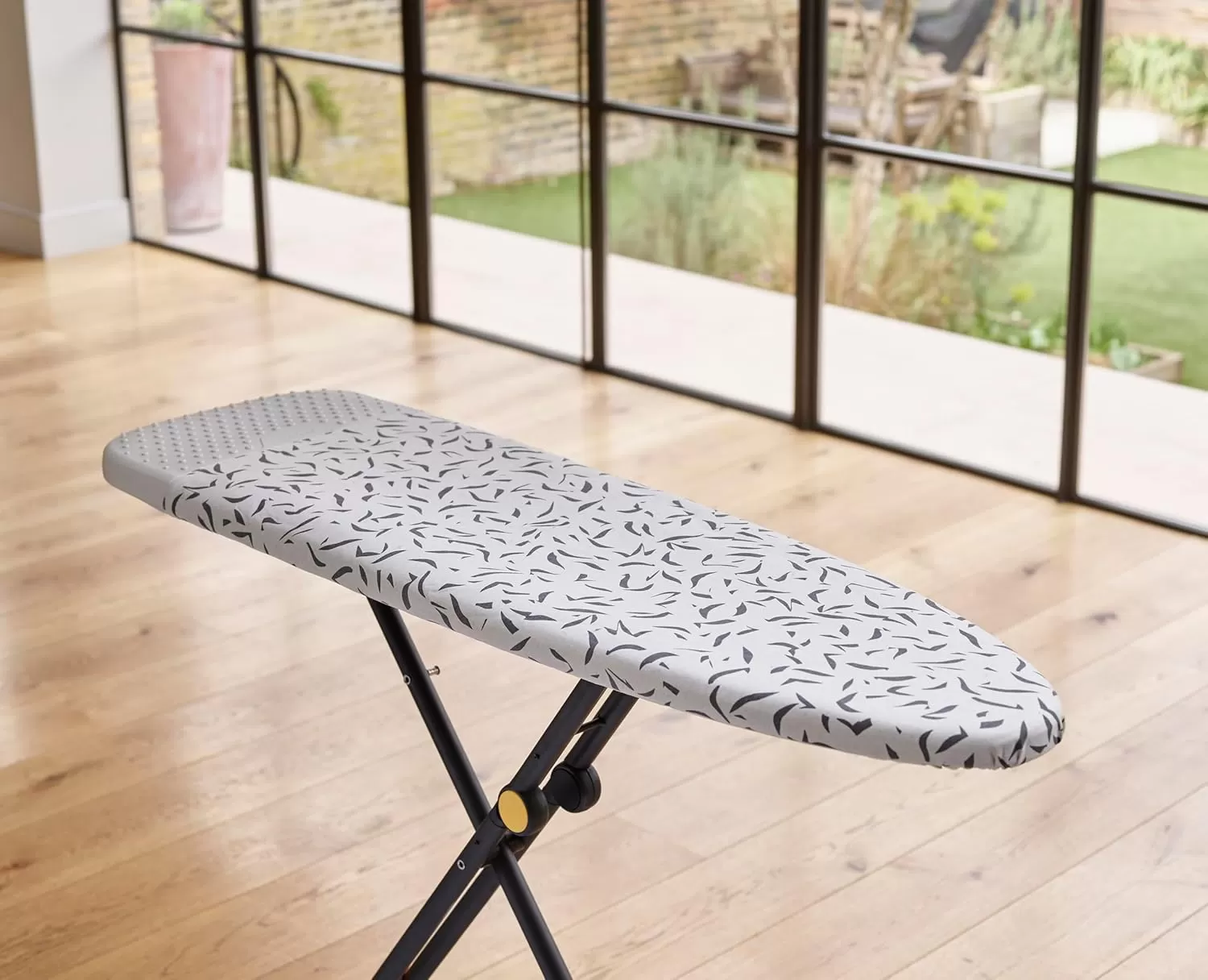 imageJoseph Joseph Glide Plus Ironing Board 130 x 38cm with Compact Adjustable Legs and Integrated Heat Resistant Steam Iron Rest Printed Antidrip Super Absorbent Cotton Cover Ecru Scatter