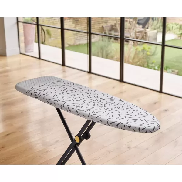 imageJoseph Joseph Glide Plus Ironing Board 130 x 38cm with Compact Adjustable Legs and Integrated Heat Resistant Steam Iron Rest Printed Antidrip Super Absorbent Cotton Cover Ecru Scatter
