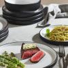 imageChristian Siriano Laro 12Piece Stoneware Dinnerware Set Plates and Bowls Set Microwave and Dishwasher Safe Dish Set for 4 GreenBlack